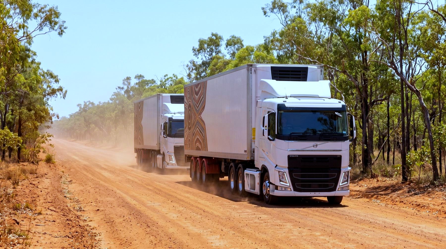 Concept render of two electric refrigerated trucks in convoy on the red dirt Peninsula Developmental Road